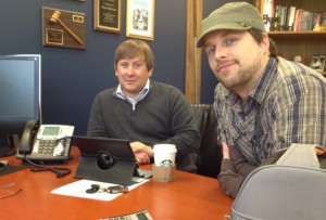 Charlie Rueb and Randy Paul listening to scientists across the globe discuss the chemistry on speakerphone.